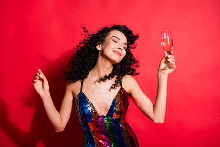 Portrait of attractive cheerful wavy-haired girl drinking wine dancing having fun amusement isolated...