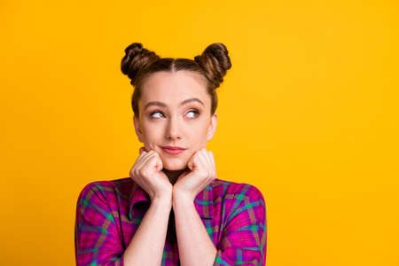 Close-up portrait of her she nice attractive pretty dreamy curious girl wearing checked shirt overthinking opinion point view isolated bright vivid shine vibrant yellow color backgroundの写真素材