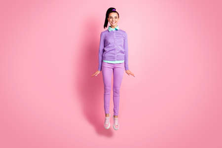 Full length photo of cute lady jump toothy smiling wear specs purple jumper pants sneakers isolated...
