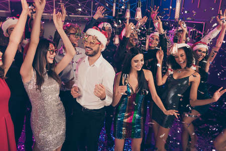 Photo of people party bearded man flirt with pretty lady wear santa spectacles cap stylish outfit modern club indoorsの写真素材