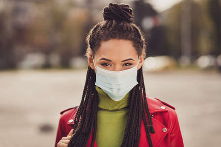 Photo of young attractive african girl wear medical mask quarantine protection prevention corona virus city centerの写真素材