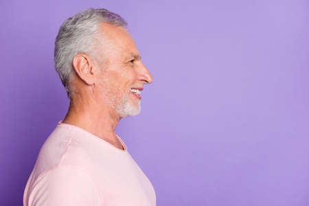 Profile photo of pensioner old man toothy beaming smile look empty space wear pink t-shirt isolated...