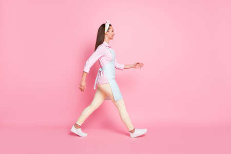 Profile side photo of nice content girl go walk copyspace wear good look clothes isolated over pink color backgroundの写真素材