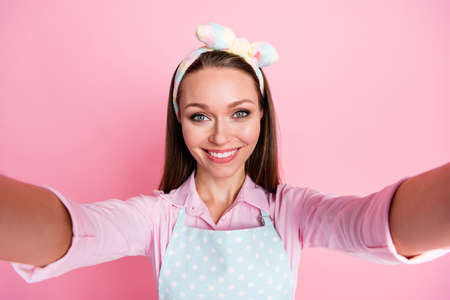 Self-portrait of her she nice attractive pretty cheerful cheery housewife blogger enjoying staying home quarantine health cleanup comfort cozy dream isolated on pink pastel color backgroundの写真素材