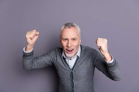 Portrait of his he nice attractive lovely positive glad cheerful cheery business shark wearing casual formal-wear celebrating good news isolated over gray pastel backgroundの写真素材