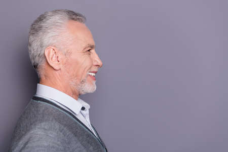 Close-up profile side view portrait of his nice attractive cheerful cheery glad content business shark wearing casual formal-wear copyspace isolated over gray pastel backgroundの写真素材