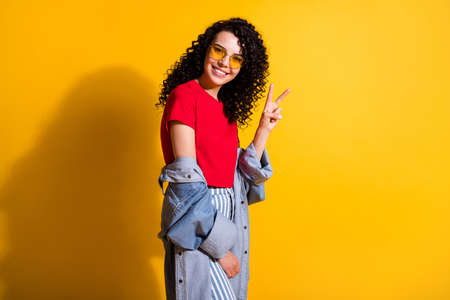 Profile photo of charming girl look camera show v-sign wear red t-shirt striped jeans jacket...