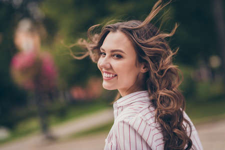 Profile photo of adorable optimistic young woman smiling long curly hair walking park wear white...