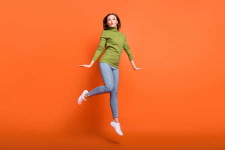 Full size photo of young attractive girl happy positive send air kiss have fun jump isolated over...