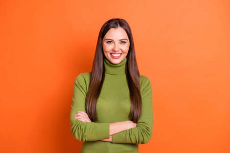 Photo of young beautiful woman happy positive smile folded hands wear casual outfit isolated over orange color backgroundの写真素材