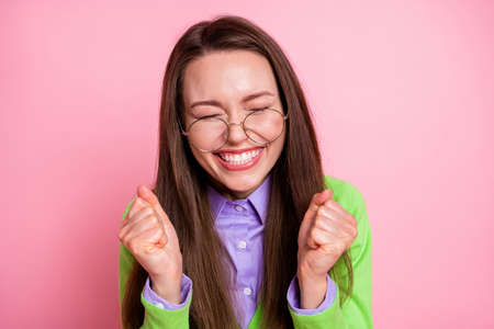 Close-up portrait of nice pretty cheerful cheery overjoyed girl geek holding fists enjoying isolated...