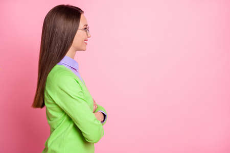 Profile side view portrait of nice pretty cheerful cheery content girl arms copy empty blank space place isolated over pink pastel color backgroundの写真素材