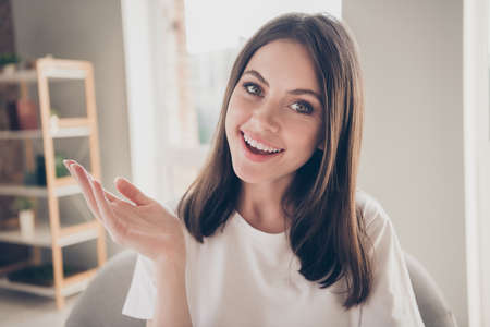 Portrait of positive girl talking on internet stream video chatting sit armchair in house wear...