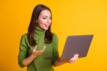 Photo of attractive lady hold notebook video call talk communicating wear green sweater isolated...