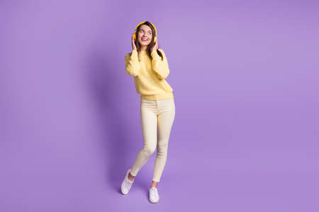 Full length body size photo of dreamy brunette listening to music wearing modern yellow headphones...