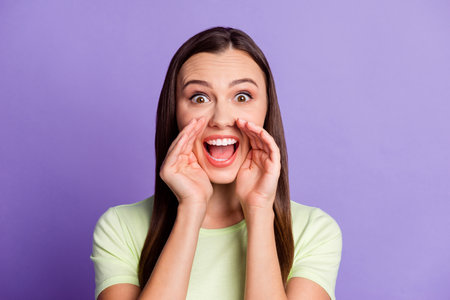 Photo of pretty positive lady hands around open mouth yell wear light green outfit isolated on...