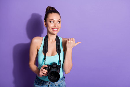 Portrait of positive girl tourism traveler lover hold digital camera point thumb finger copyspace...