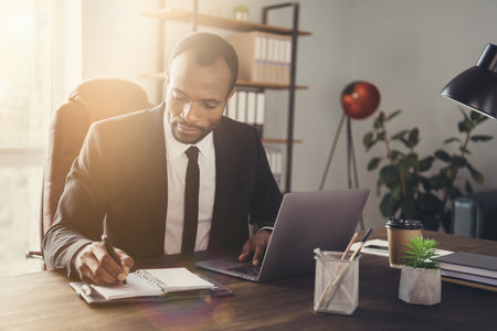 Close-up portrait of his he nice attractive classy smart clever focused experienced guy director writing weekly plan strategy appointment meeting candidates at workplace workstation indoorsの写真素材