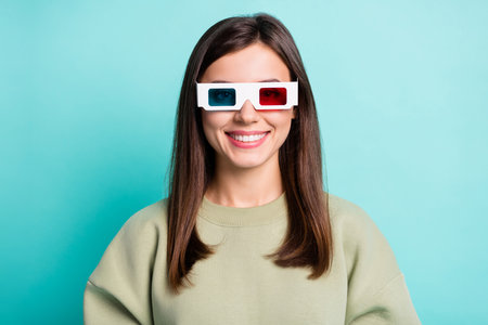 Photo portrait of smiling woman in 3d glasses isolated on vivid cyan colored backgroundの写真素材