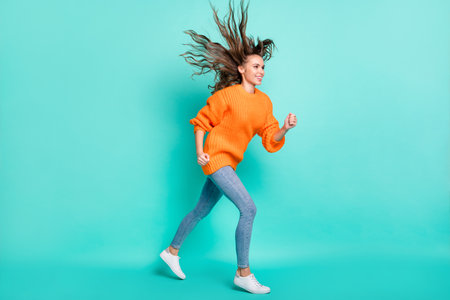 Full size profile side photo of young beautiful cheerful smiling girl go walk with flying hair...