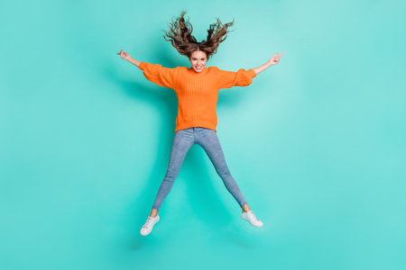 Full size photo of young happy excited smiling funny careless girl jumping in star pose isolated on...