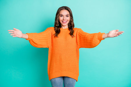 Photo of young lovely pretty happy positive cheerful girl with open arms embrace you isolated on turquoise color backgroundの写真素材