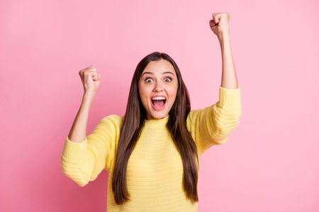 Photo of young excited happy crazy shocked amazed beautiful girl raise fists in victory open mouth isolated on pink color backgroundの写真素材