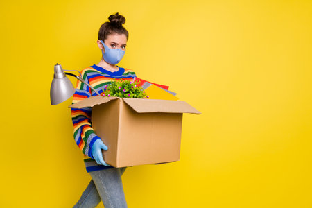 Profile photo of girl go with box got fired wear blue mask gloves from corona rainbow sweater pants isolated on bright yellow color backgroundの写真素材