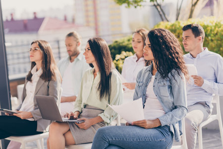 Profile side view portrait of attractive smart entrepreneurs attending conference committee listening speaker studying developing outside outdoorの写真素材
