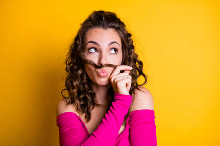 Photo portrait of dreamy brunette woman with plump lips making fake hair moustache holding with one...