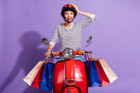 Photo of charming moto lady dressed striped clothes red helmet sitting motorcycle arm head isolated...