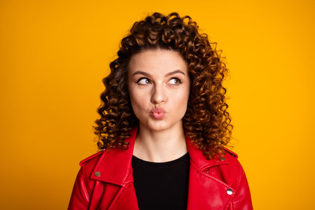 Portrait of curious girl look copyspace send air kiss isolated over shine color backgroundの写真素材