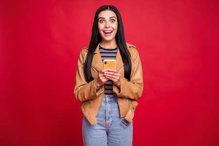 Portrait of astonished positive person open mouth unbelievable blog comment isolated on red color...