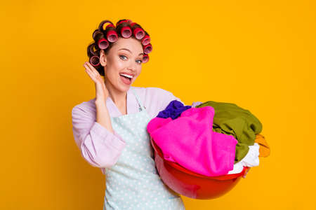 Photo of shocked girl hold basin dirty clothes wear bath robe isolated bright color backgroundの写真素材