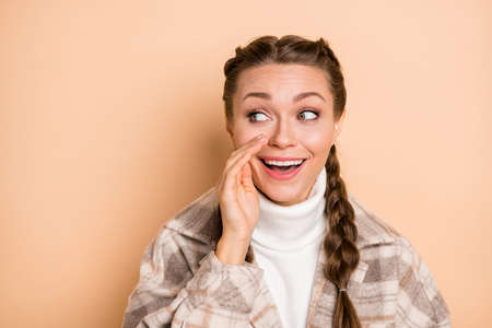 Photo of young beautiful smiling cheerful pretty lovely girl tell secret look copyspace isolated on...