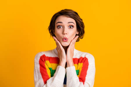 Photo of funny crazy young lady palms cheekbones look camera wear striped sweater isolated yellow...