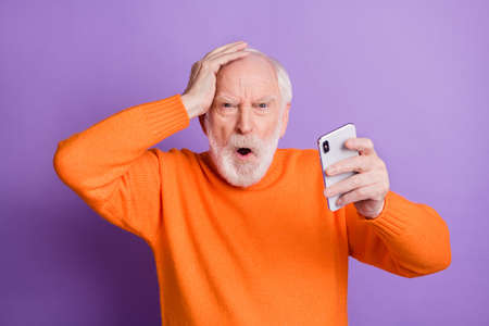 Photo of irritated bearded man arm on head open mouth unexpected bad fake news isolated on magenta color backgroundの写真素材