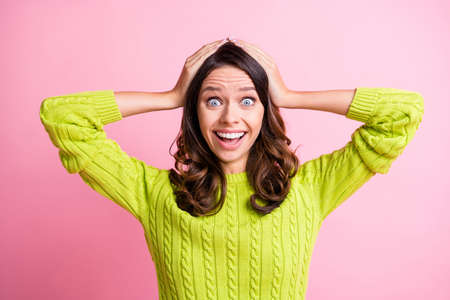 Photo of crazy surprised young girl open mouth hands head wear green sweater isolated pink color...