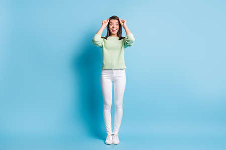 Full length photo of impressed girl raise her eyeglasses scream isolated over blue pastel color backgroundの写真素材