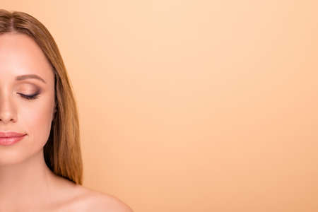 Close-up cropped view portrait of her she nice-looking attractive lovely pure calm straight-haired middle-aged girl moisturizing natural organic makeover copy space isolated over beige backgroundの写真素材