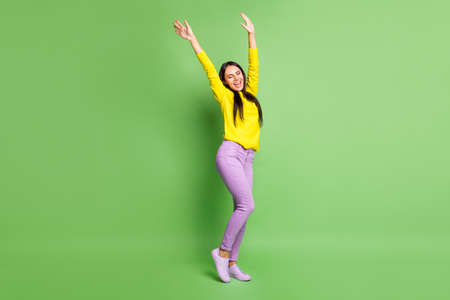 Full length portrait of charming cheerful girl closed eyes raise hands open mouth dance isolated on...