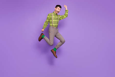 Full size profile side photo of young happy positive crazy smiling man jump in victory isolated on...