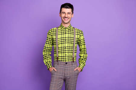 Photo of young handsome happy positive good mood businessman in glasses smiling isolated on purple color backgroundの写真素材