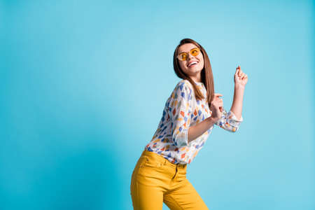 Photo portrait of brunette dancing at party laughing wearing printed casual shirt smiling isolated on bright blue color backgroundの写真素材