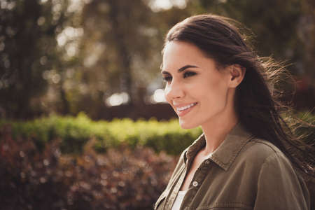 Photo of tender happy charming young girl look side white smile wear brown shirt park street outsideの写真素材