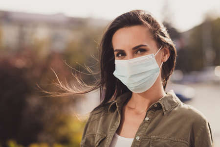 Photo portrait of dreamy gorgeous woman wearing white face mask outdoors