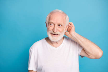 Photo of aged bearded man hand touch head look empty space thinking isolated on blue color...