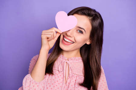 Photo of lovely cheerful person hold heart card cover eye wear retro outfit isolated on purple color...