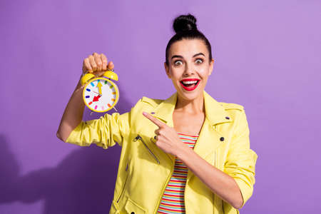Photo of young happy excited beautiful girl woman female showing gesture point finger at clock...