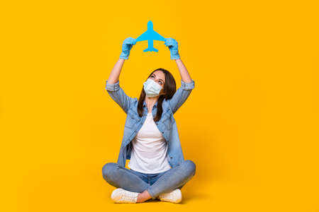Portrait of her she nice girl sit crossed leg wearing safety mask rising hands up holding paper...